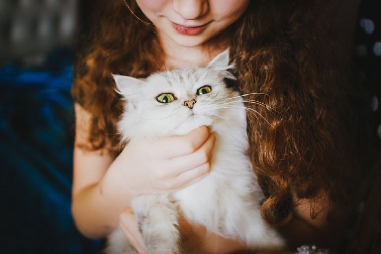 Une fille avec un chat blanc
